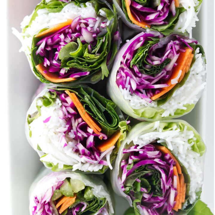 A close up of colorful spring rolls sliced in half.