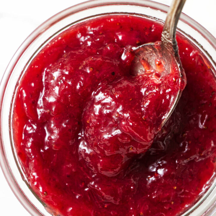 A spoon in a jar of jam.