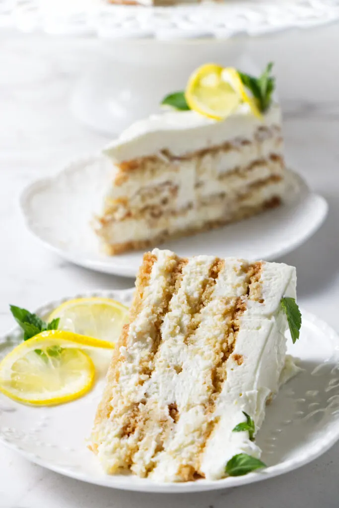 Two slices of cake with lemon garnish.