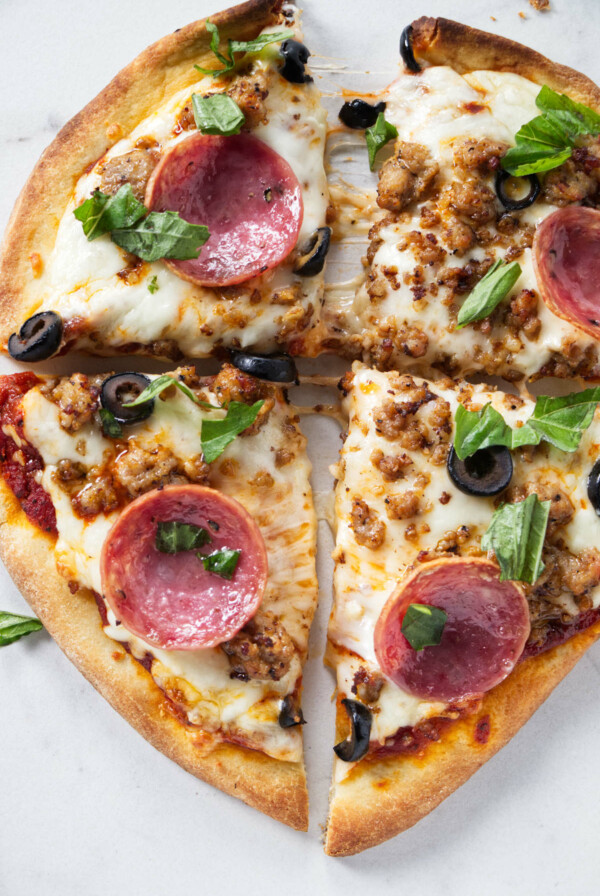 Pizza fixings on naan bread.