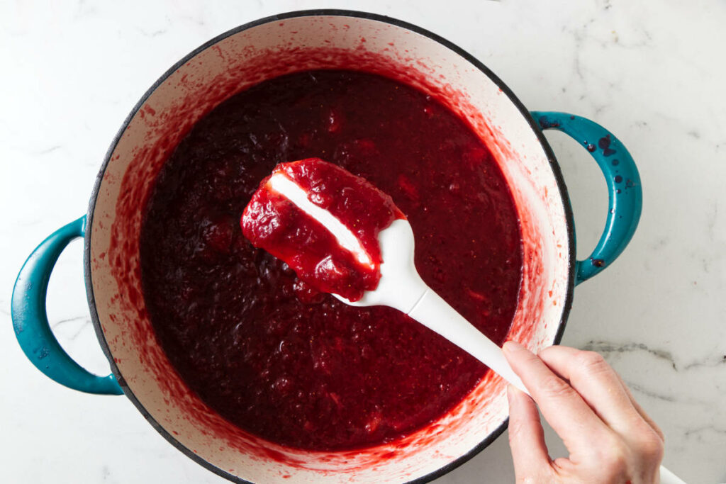 Testing the thickness of rhubarb strawberry jam.