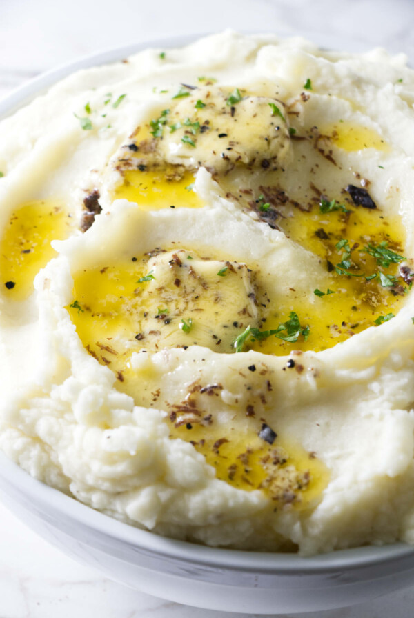 Mashed potatoes with truffle butter melting on top.