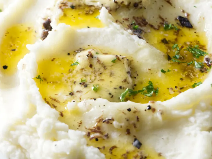 Mashed potatoes with truffle butter melting on top.