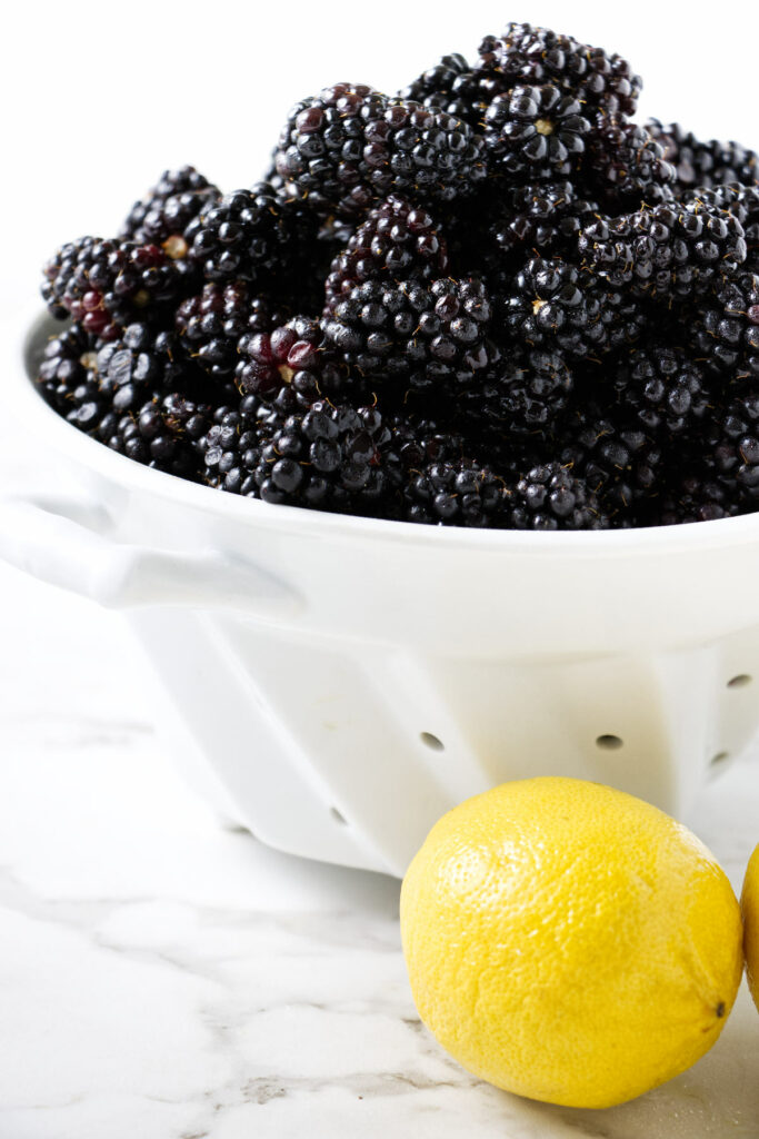 Fresh blackberries and a lemon.