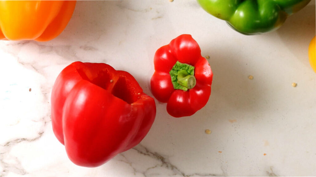 A bell pepper with the top cut off.