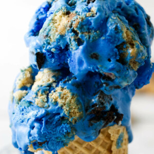 Two scoops of blue ice cream on an ice cream cone.