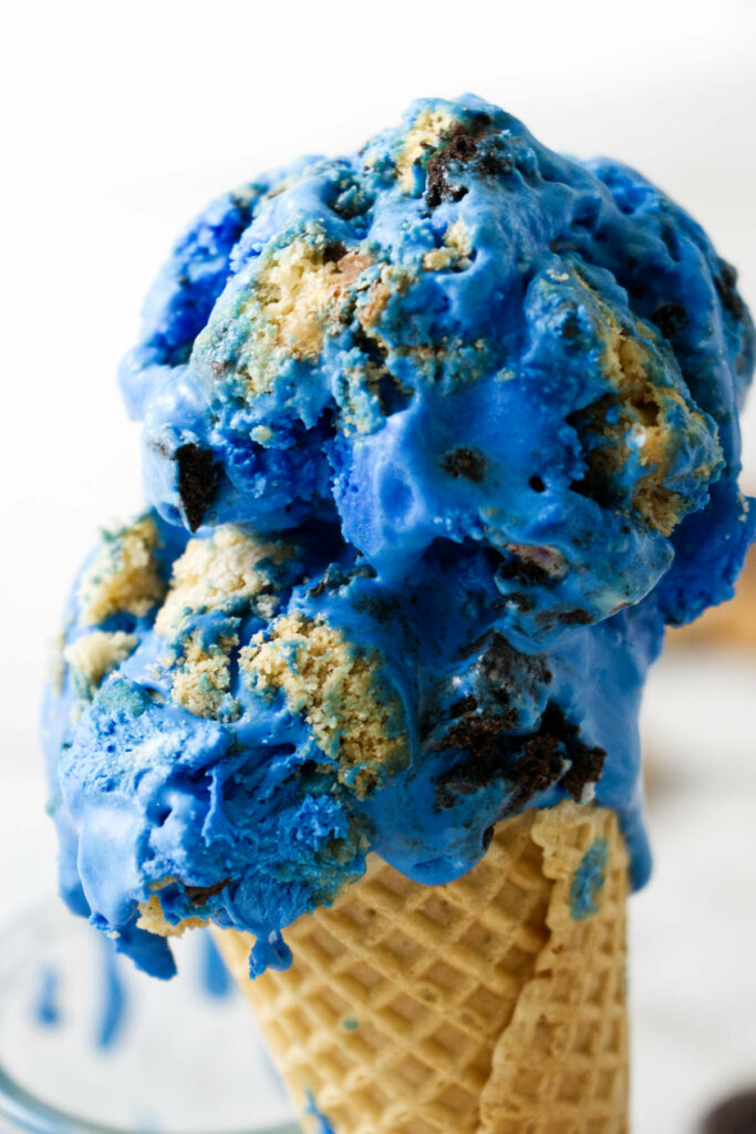 Two scoops of blue ice cream on an ice cream cone.