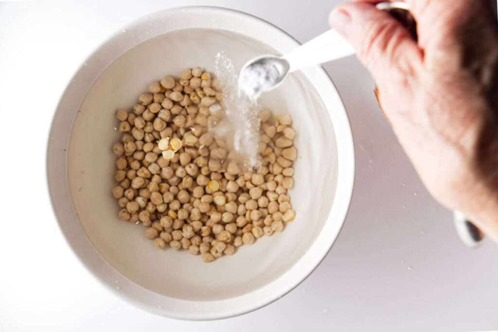 Adding baking soda to soaking water for garbanzo beans.