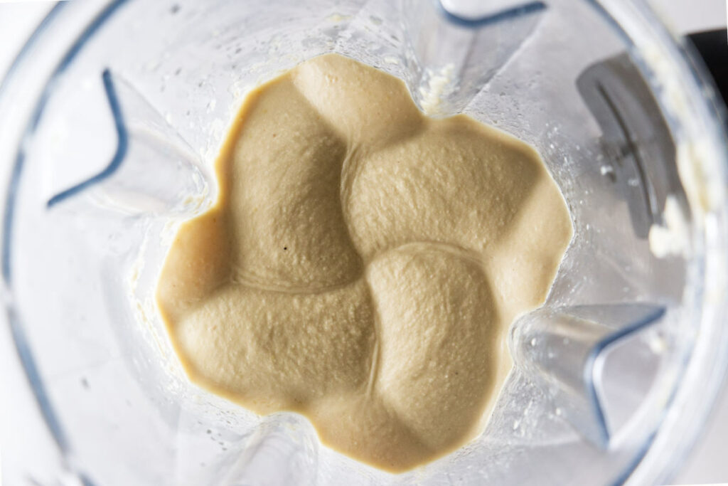 Blending hummus in a blender.