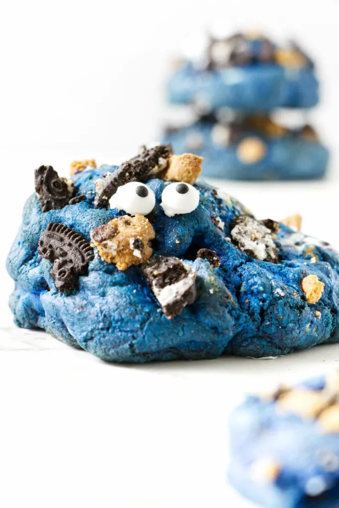 A large blue cookie with two stacked cookies in the background.