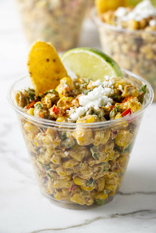 A picnic cup filled with Mexican street corn salad.