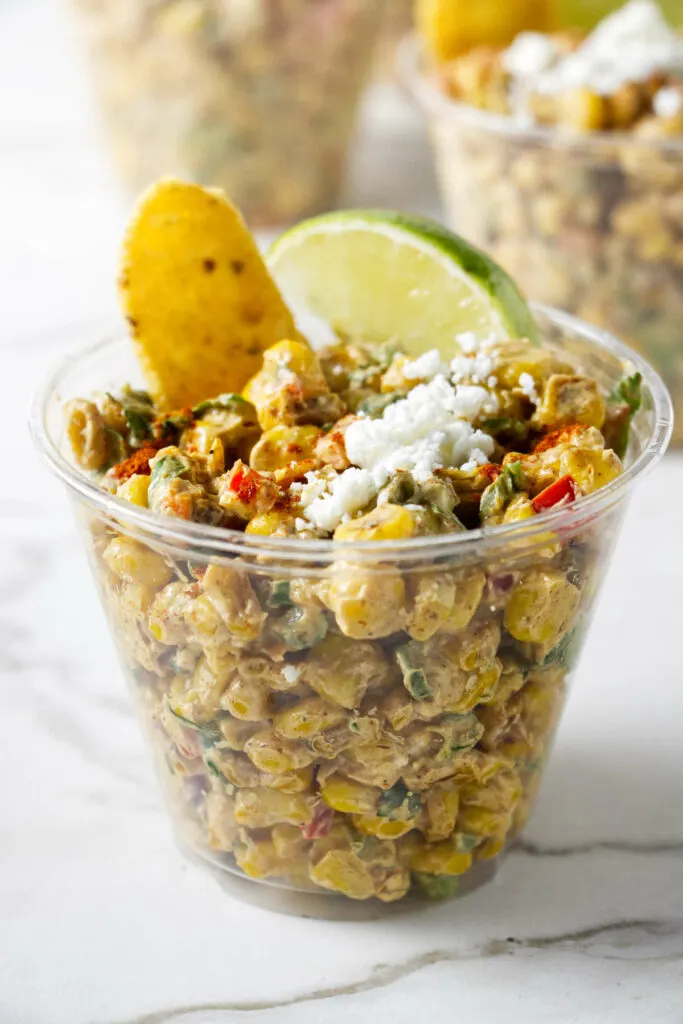 A picnic cup filled with Mexican street corn salad.