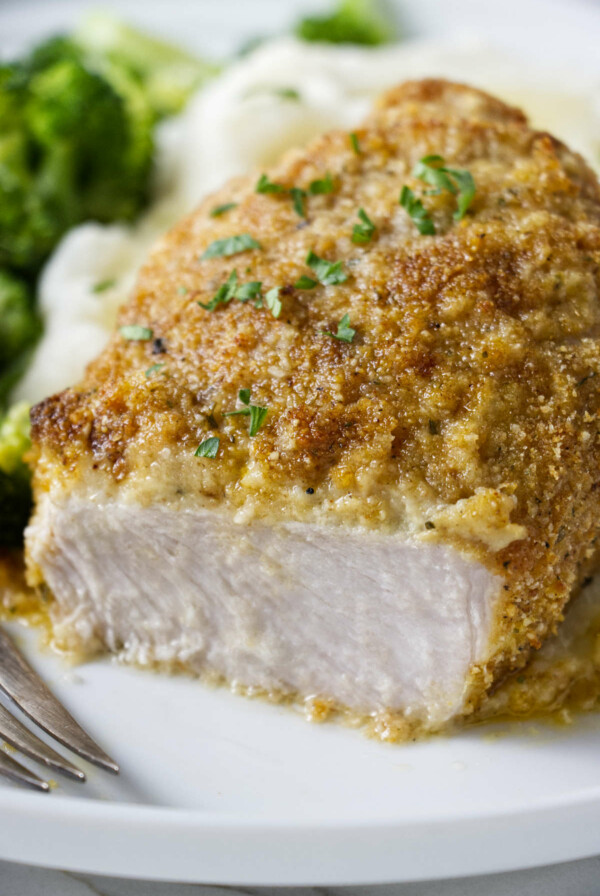 A pork chop with a seasoned bread crust.