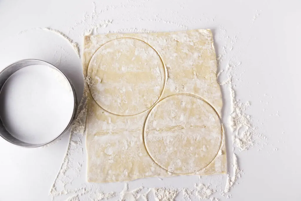 Cutting circles out of pastry dough.