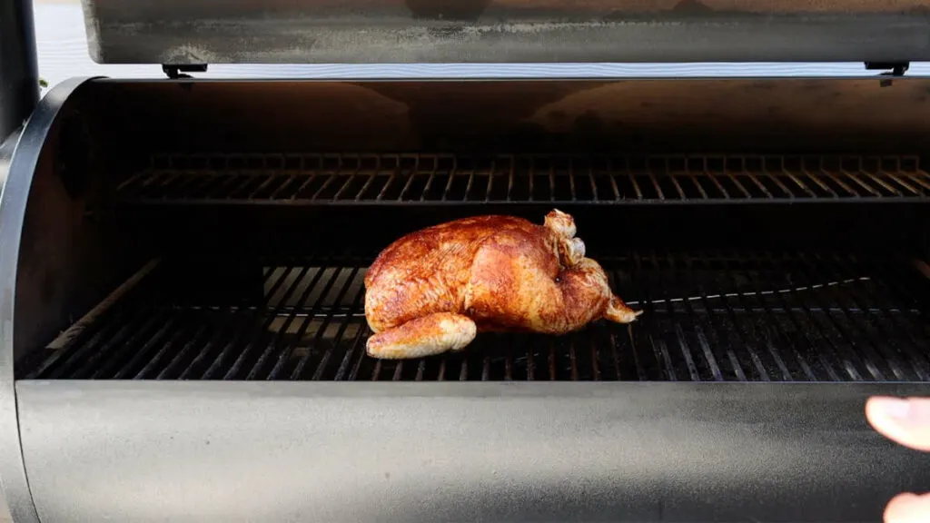 A whole chicken on a Traeger grill.
