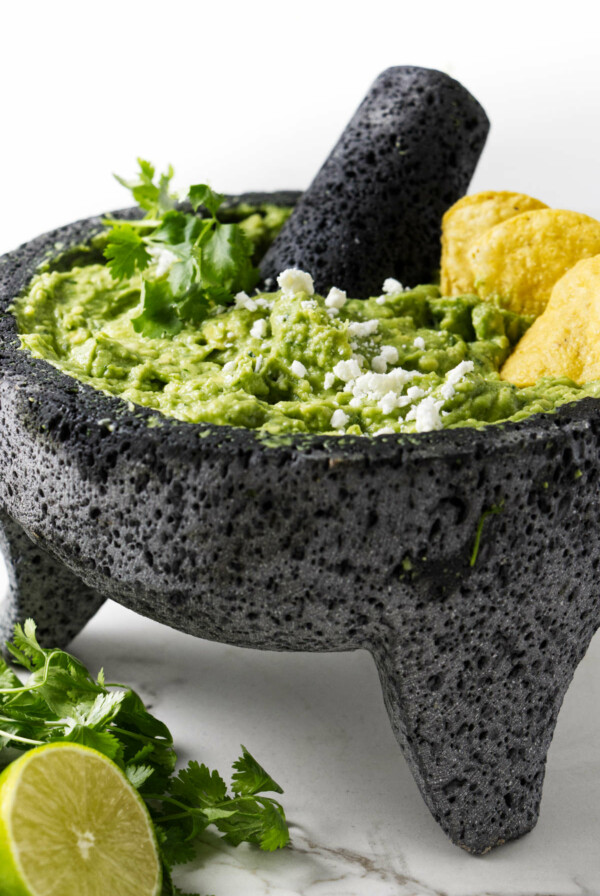 Fresh guacamole in a mortar and pestle.