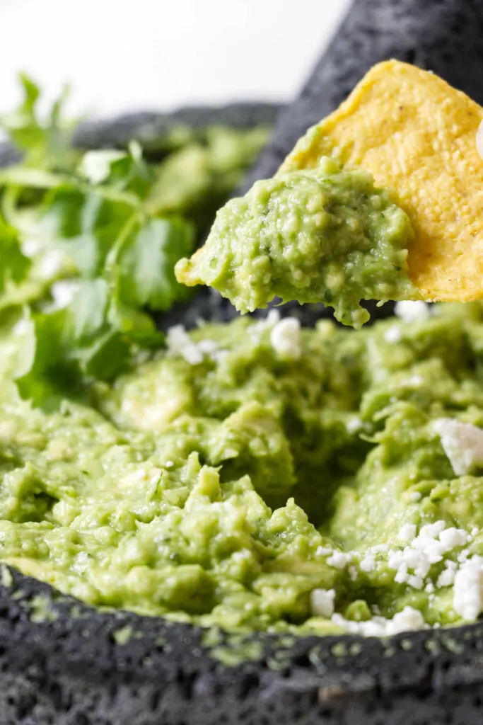 Dipping a chip in guacamole.