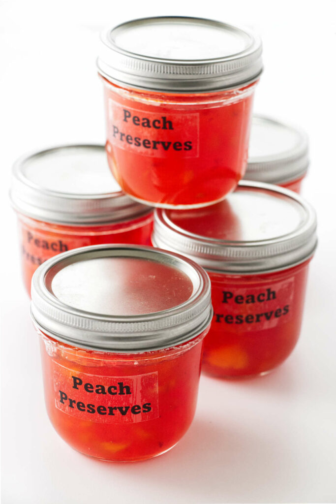 Jars of old fashioned peach preserves.