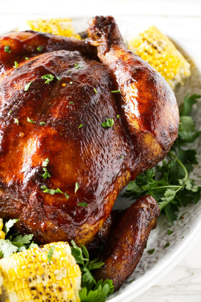 A whole chicken with roasted corn.