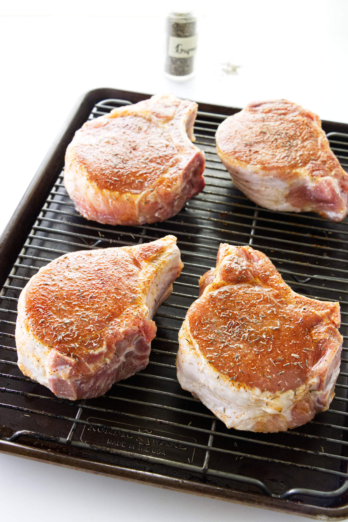 Seasoned pork chops ready for the broiler