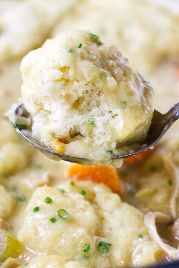 A fluffy dumpling on a soup spoon.