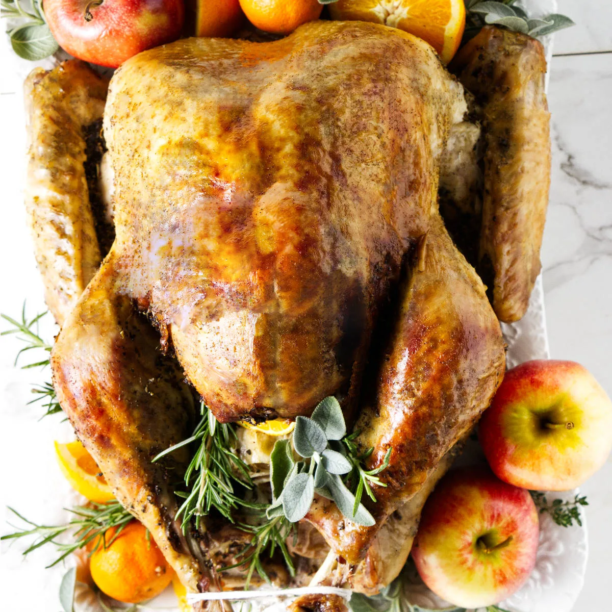 A golden brown turkey on a serving platter.