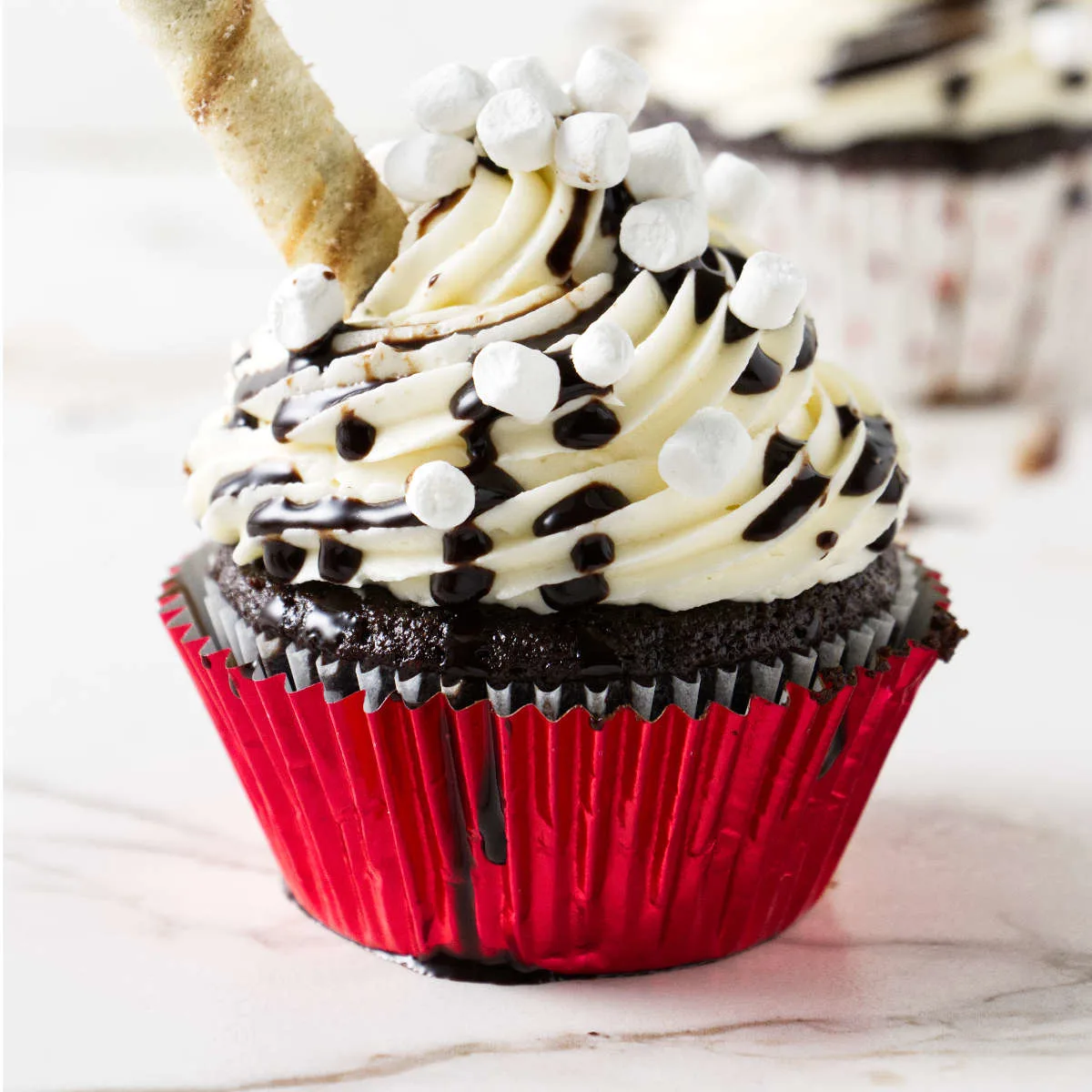 Chocolate with buttercream, chocolate drizzle, and miniature marshmallows.