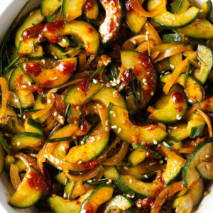 A serving bowl filled with spicy cucumber salad.