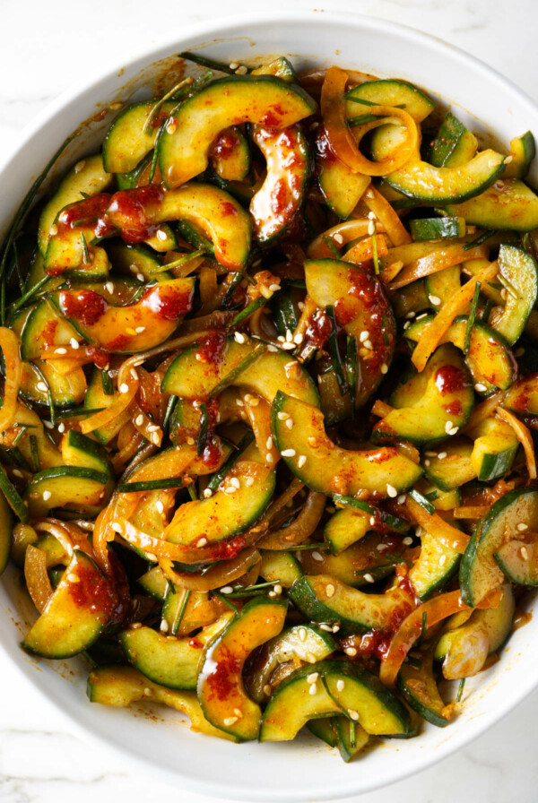 A serving bowl filled with spicy cucumber salad.