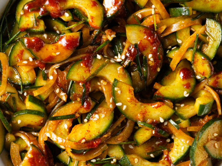 A serving bowl filled with spicy cucumber salad.