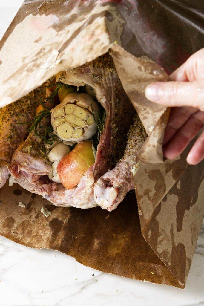 Placing a turkey in a brown paper bag.