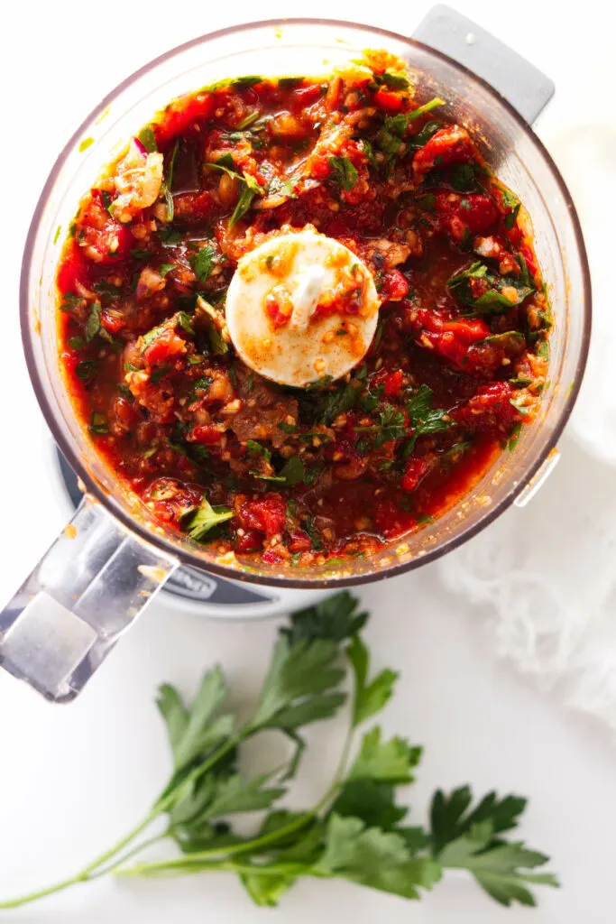 mini food processor with red chimichurri mixture