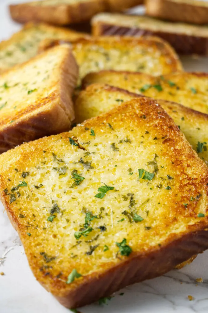 A slice of Texas toast bread toasted with garlic butter.