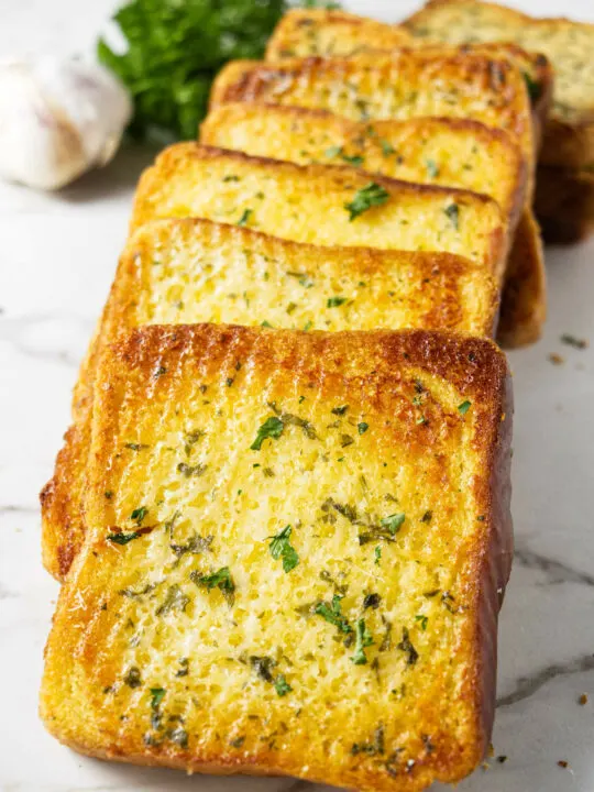 Several thick slices of bread toasted with garlic butter.