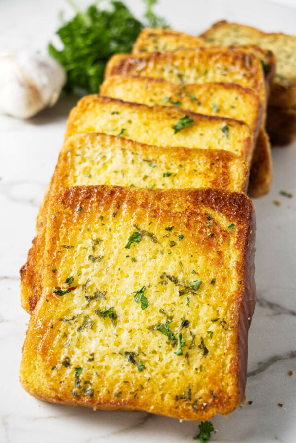 Several thick slices of bread toasted with garlic butter.