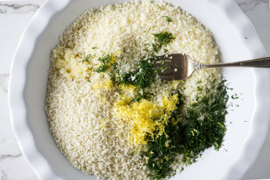 Mixing fresh herbs with Panko bread crumbs.