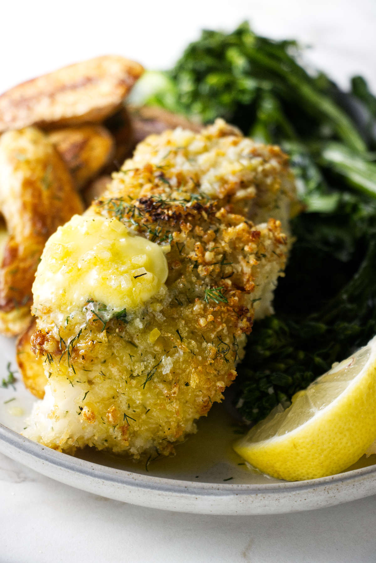 A cooked haddock with panko parmesan crust.