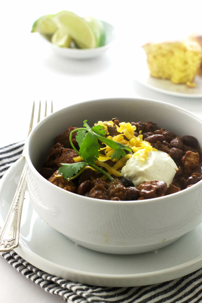 A bowl of pork chili with beans.