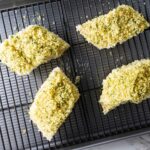 Four haddock fillets on a baking sheet.