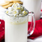 A glass mug filled with white hot chocolate.