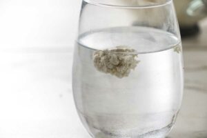 Testing the dough in a glass of water.