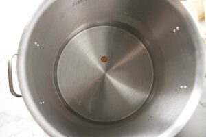 Dropping a coin in the bottom of a pot.