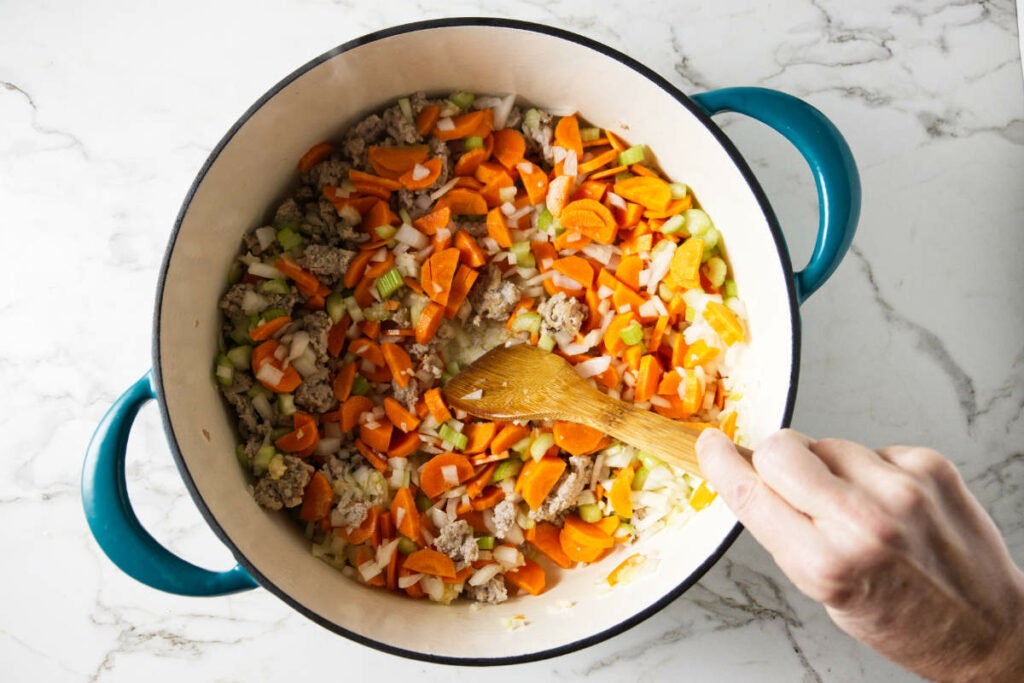 Sautéing vegetables in a soup pot.