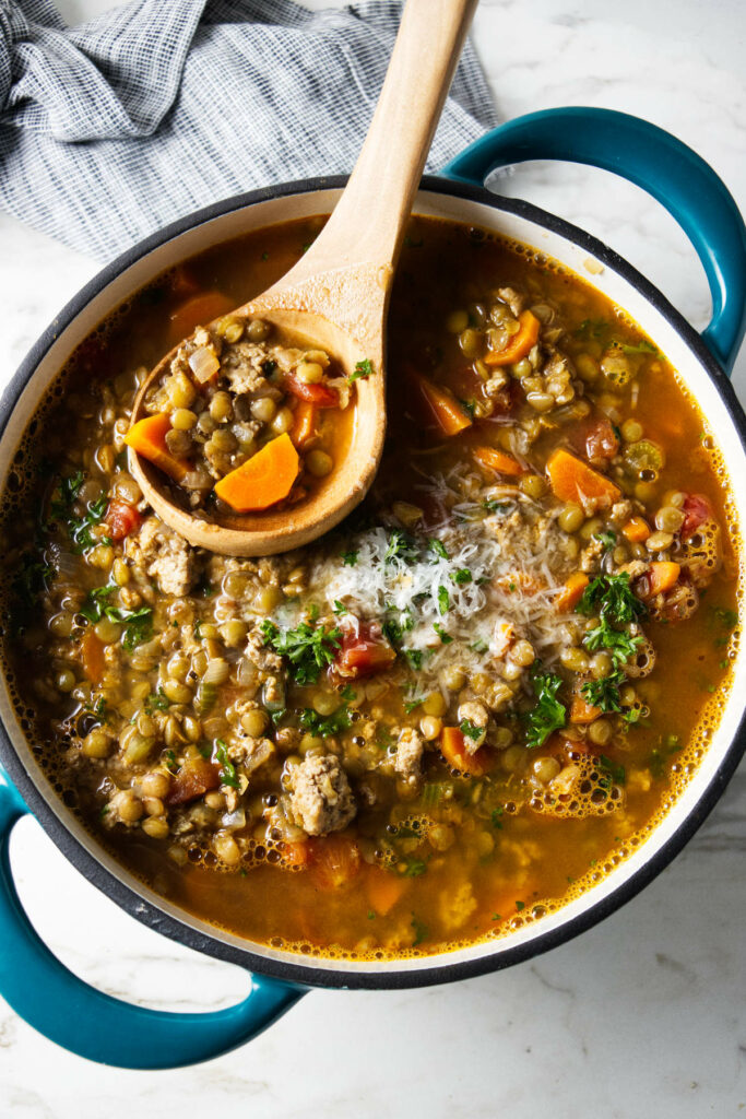 A ladle in a pot of lentil soup.