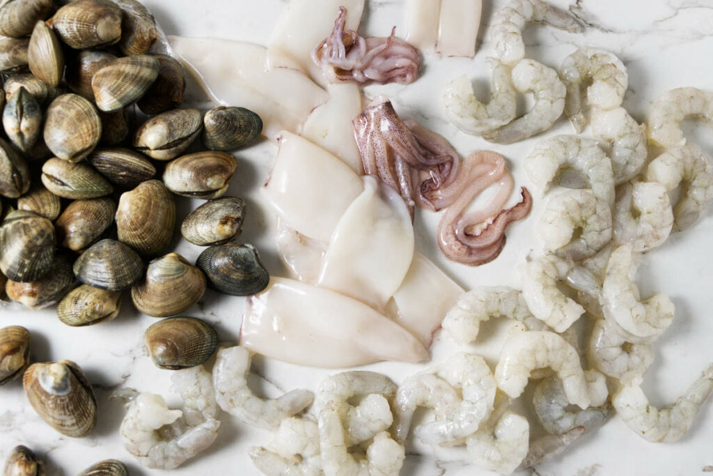 Clams, squid, and shrimp, cleaned and ready to cook.