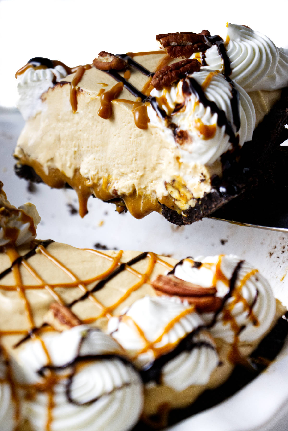 Removing a slice of pie from a pie dish.