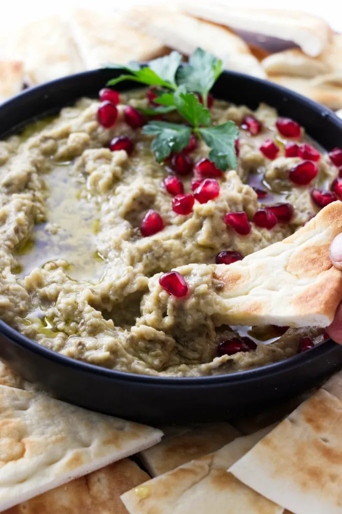 Dipping pitta bread in Lebanese baba ganoush.