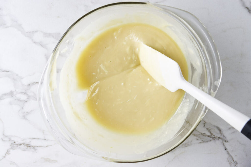 Stirring melted white chocolate and butter together.