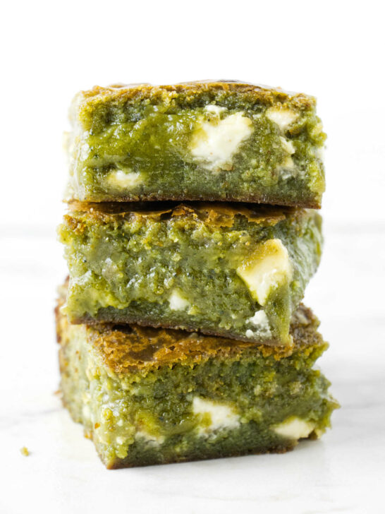 Three matcha brownies stacked on top of each other.