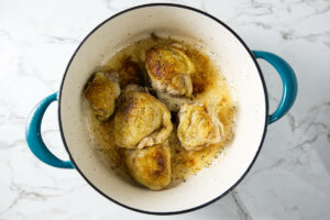 Browning chicken thighs in a Dutch oven.